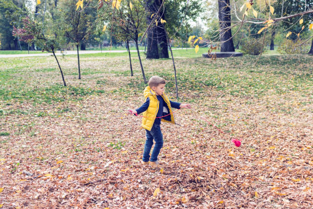 istock Playful kid having fun in fall season. 1015639292