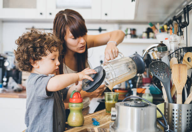 istock Mother and her little son preparing healthy smoothie 1015639416