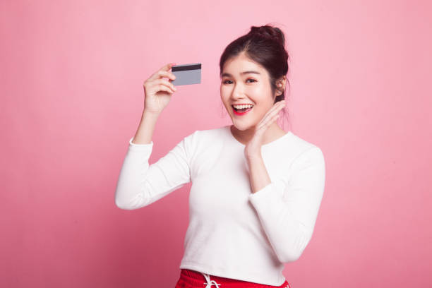 istock Young Asian woman happy with  blank card. 1015639532