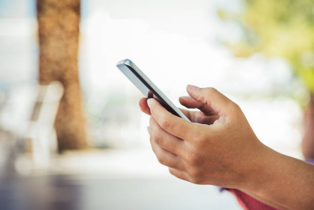 istock Girl using her phone in a beach bar lounge 1015645302