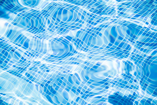 Close up of transparent pool water and tile pattern
