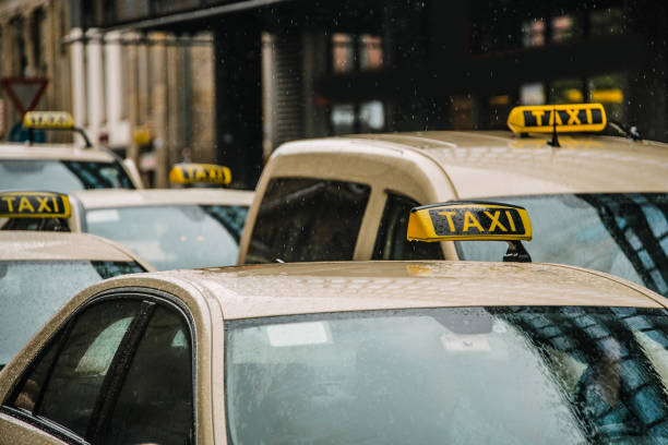istock Row of taxis under rain 1015661382