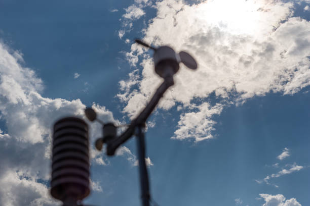 Home weather station on a background of blue sky with the sun behind the clouds. Measurement of temperature, humidity and wind direction Home weather station on a background of blue sky with the sun behind the clouds. Measurement of temperature, humidity and wind direction german barometer stock pictures, royalty-free photos & images