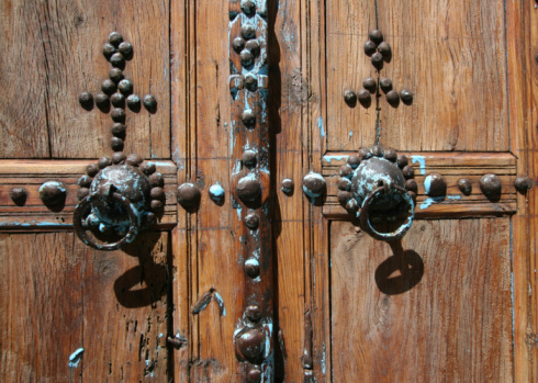 Wooden door of a traditional Konya house in Aziziye District. Metal doorknob.