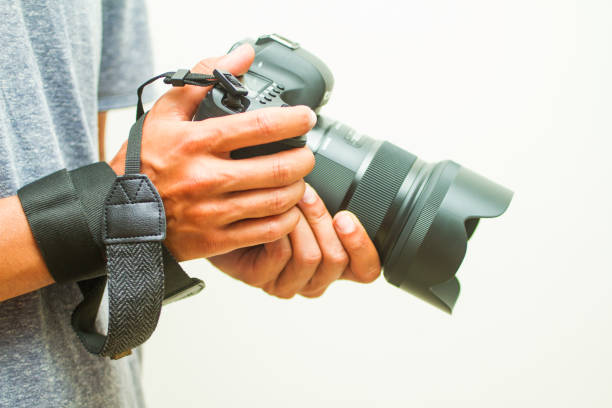 istock photographer holding camera, close-up. front view, Selective focus. 1015684284