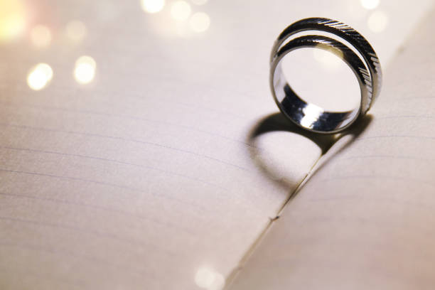 istock Wedding background with rings and heart shadow 1015705596