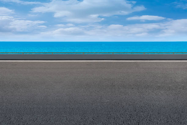 istock Empty highway asphalt road with beautiful sky ocean landscape 1015725600