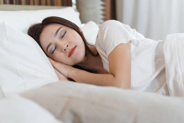 istock woman sleeping on a bed 1015768514