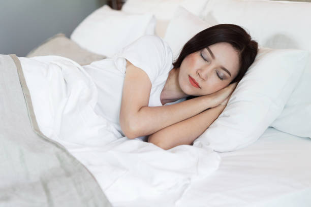 istock woman sleeping on a bed 1015768530