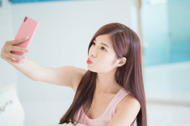 istock woman selfie on the bed 1015812282