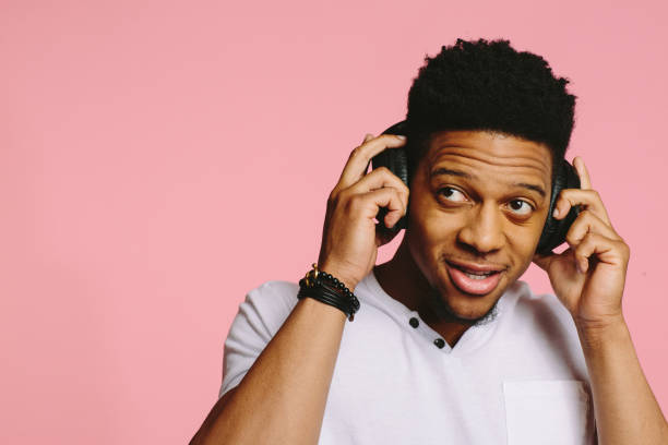 istock Young man holding headphones and looking to side 1015812626