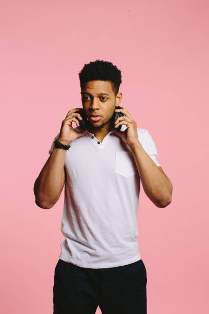 istock Standing young man with headphones, looking to side 1015812634