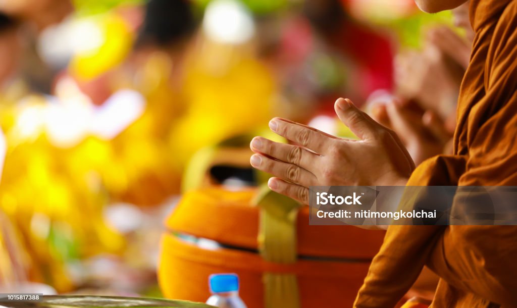 hand of monk in Buddhist prayer process. Buddhism Stock Photo