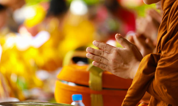 hand of monk in Buddhist prayer process. stock photo