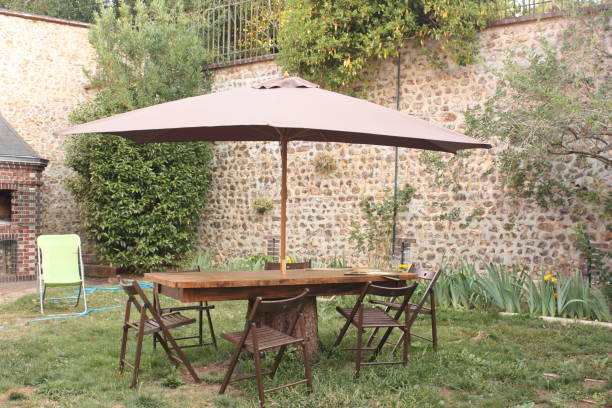 istock Garden table equipped with parasol  Walled garden 1015817394