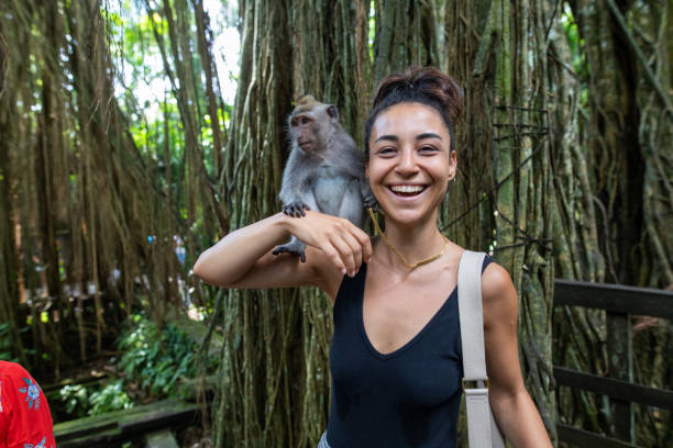istock Woman interacting with a monkey in Bali, Indonesia 1015820142