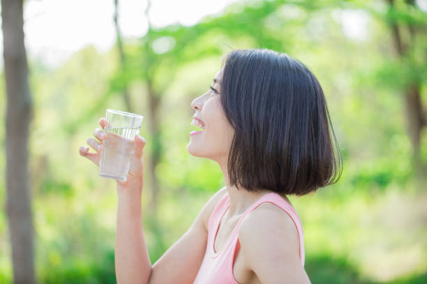istock woman drink water happily 1015820396