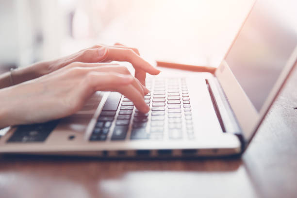 istock business girl closeup hand typing on modern thin and light computer laptop keyboard 1015823076