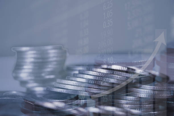 istock Double exposure of coin stack with stock market screen chart board and candle stick for financial business and investor analysis concept. 1015823422