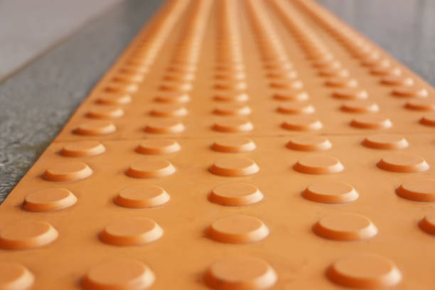 istock Tactile paving  is a system of textured ground surface indicator found on footpaths, stairs and train station platforms to assist pedestrians who are visually impaired 1015828520
