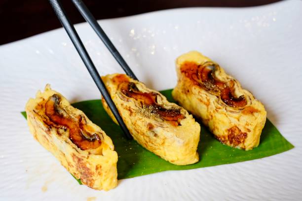 istock Use chopstick to pick up Japanese egg rolls with Grilled Eel (Unagi) 1015833292