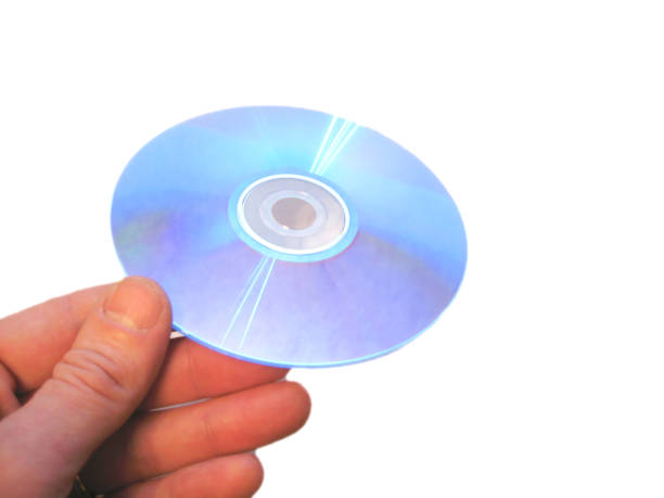 istock Mans hand holding compact disc on the finger isolated 1015836038