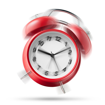 Red alarm clock ringing on white background.