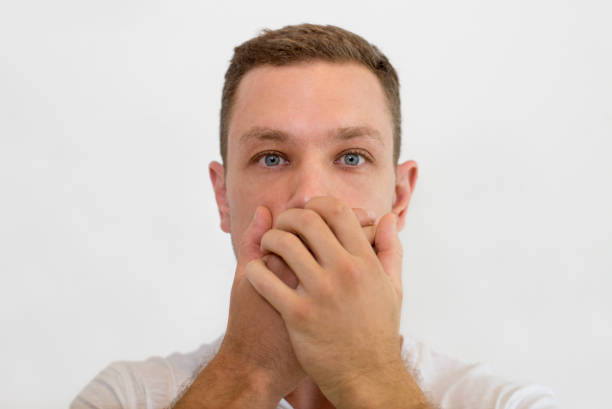 istock Shocked handsome man covering mouth with both hands 1015836474