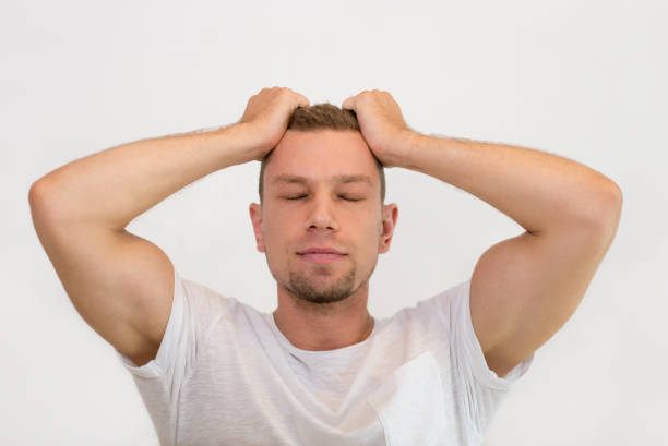 istock Worried young handsome man clutching head 1015836700