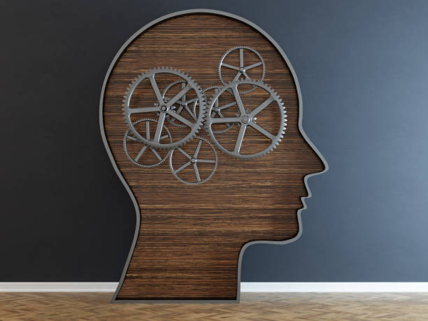 istock Head with a gear in front of black wall 1015839674