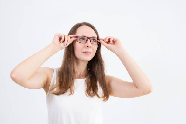 istock Concentrated young woman testing glasses and looking away 1015843990