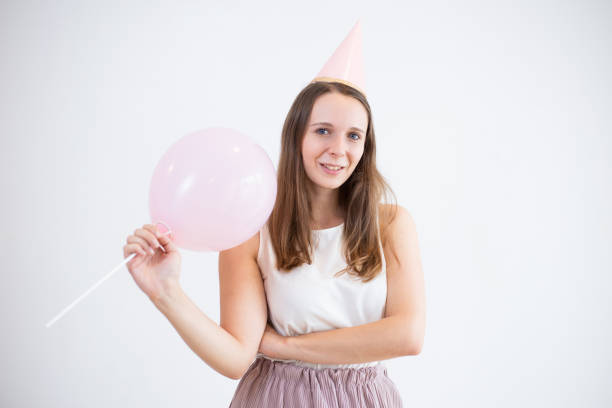 istock Positive young woman celebrating birthday alone 1015844134