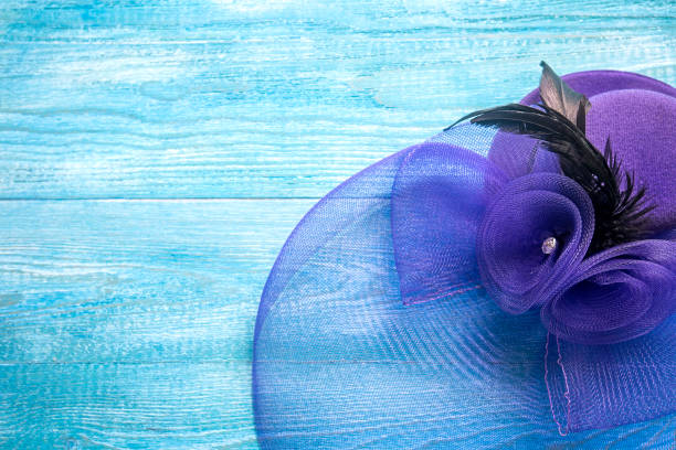istock Elegant lady's hat on a blue wooden background 1015844142