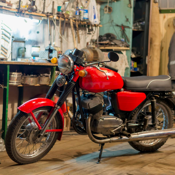 Red vintage retro motorcycle parked in the garage