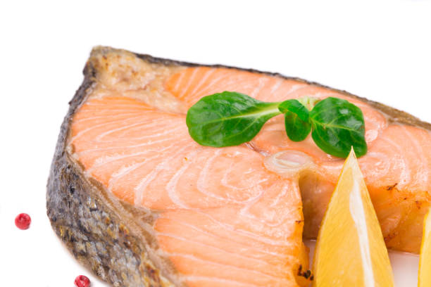 istock Fried salmon fillet on plate with lemon. 1015849836