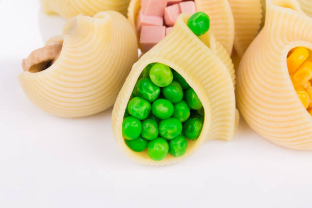 Pasta shells stuffed with vegetables and sausage. Close-up.