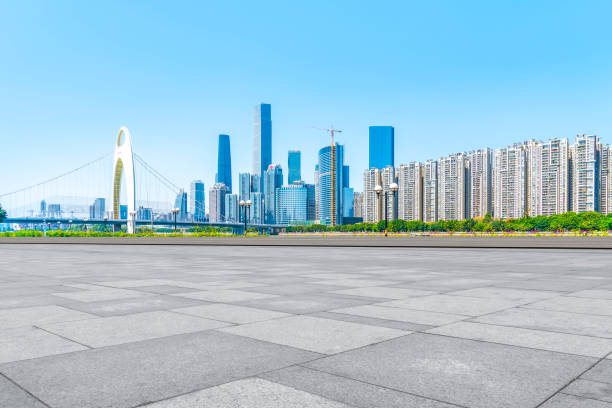 istock Empty square floor tiles and modern architecture in Guangzhou 1015852560