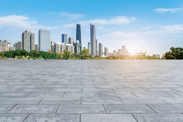 istock Empty square floor tiles and modern architecture in Guangzhou 1015852564