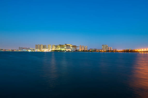 istock Waterfront city buildings at night 1015855032
