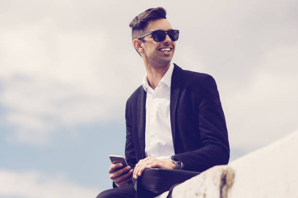 istock Happy young man in suit enjoying stroll 1015855160