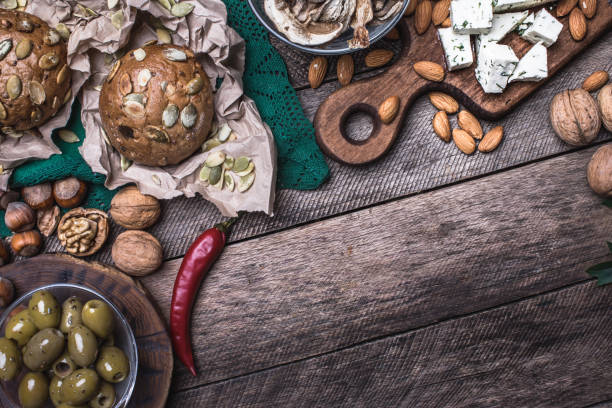 istock Lunch olives, nuts and  sheep cheese with bread in rustic style 1015855440