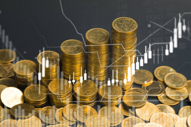 istock Double exposure of coin stack with stock market screen chart board and candle stick for financial business and investor analysis concept idea. 1015855748