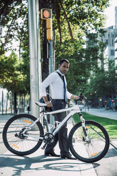 istock Office Worker with Bicycle Crossing Street 1015858408