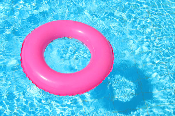 istock inflatable pink ring in swimming pool. 1015859044