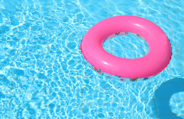 istock inflatable pink ring in swimming pool. 1015859070