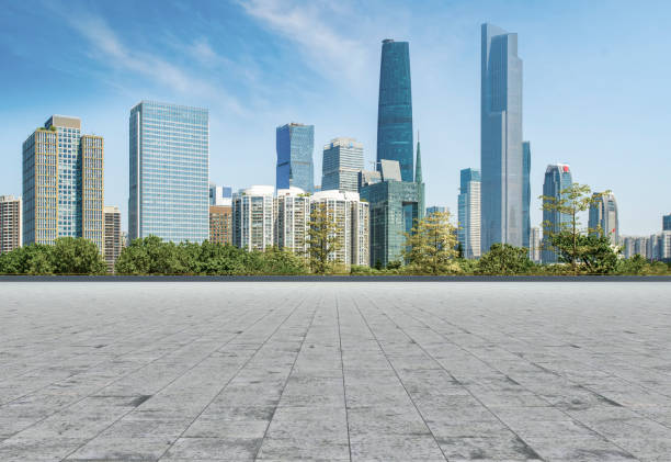 istock Empty square floor tiles and modern architecture in Guangzhou 1015859432