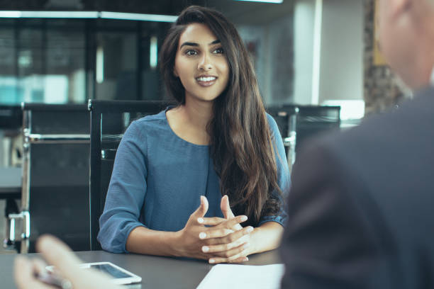 istock Smiling female client talking to male manager 1015863904