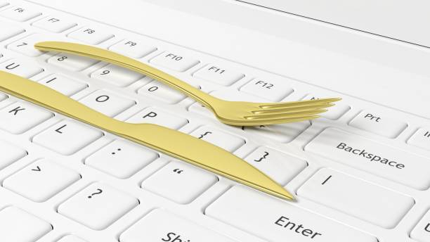 istock Golden fork and knife on laptop keyboard, conceptual background. 1015863996