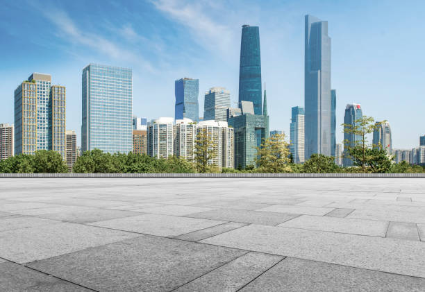 istock Empty square floor tiles and modern architecture in Guangzhou 1015864016
