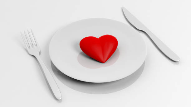 istock Heart on plate with fork and knife, isolated on white background. 1015864062